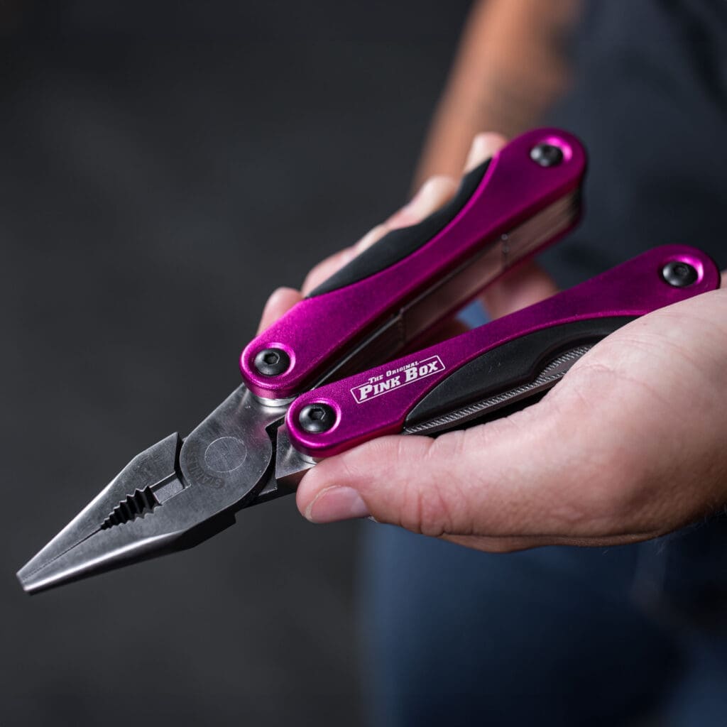 person holding a pink multi-tool