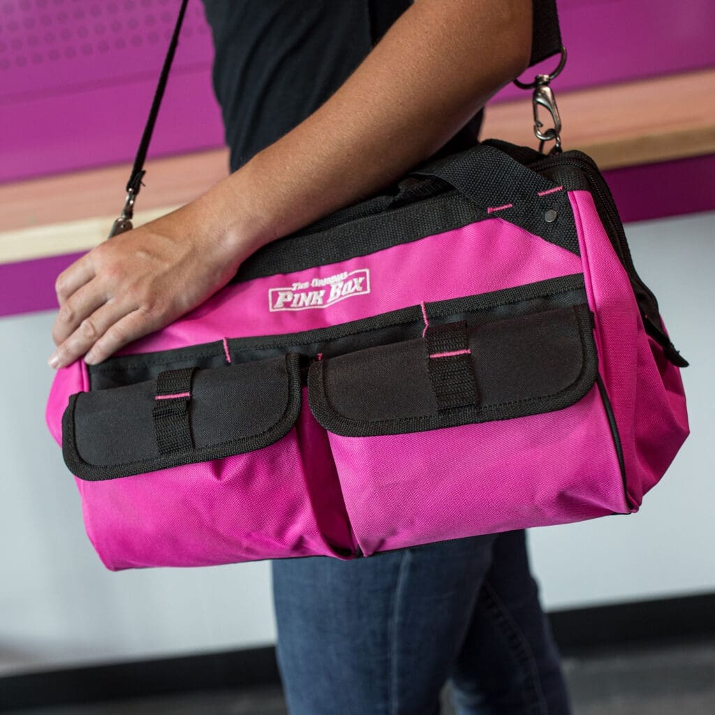 person carrying pink canvas tool bag