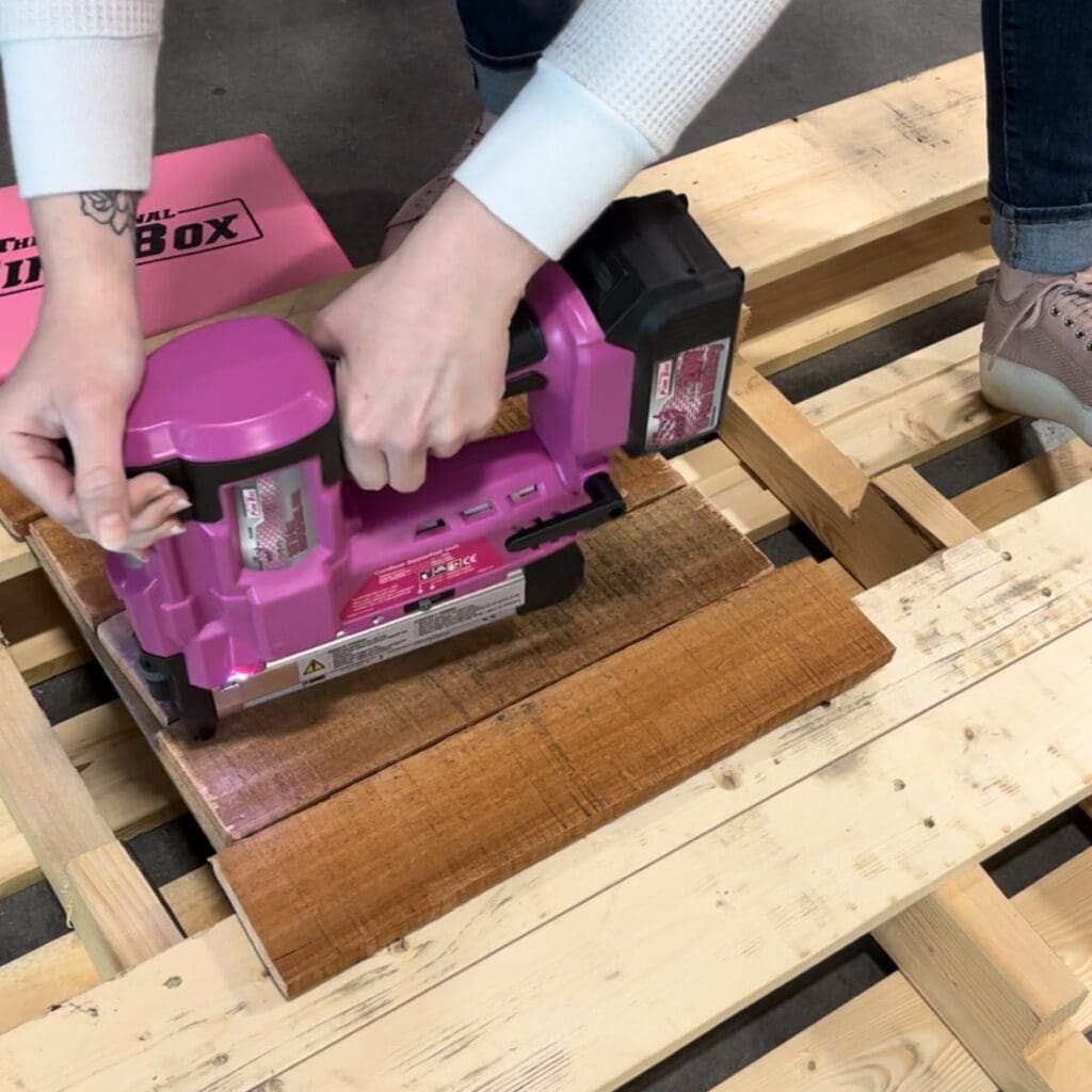 using a nail gun to attach planks to board